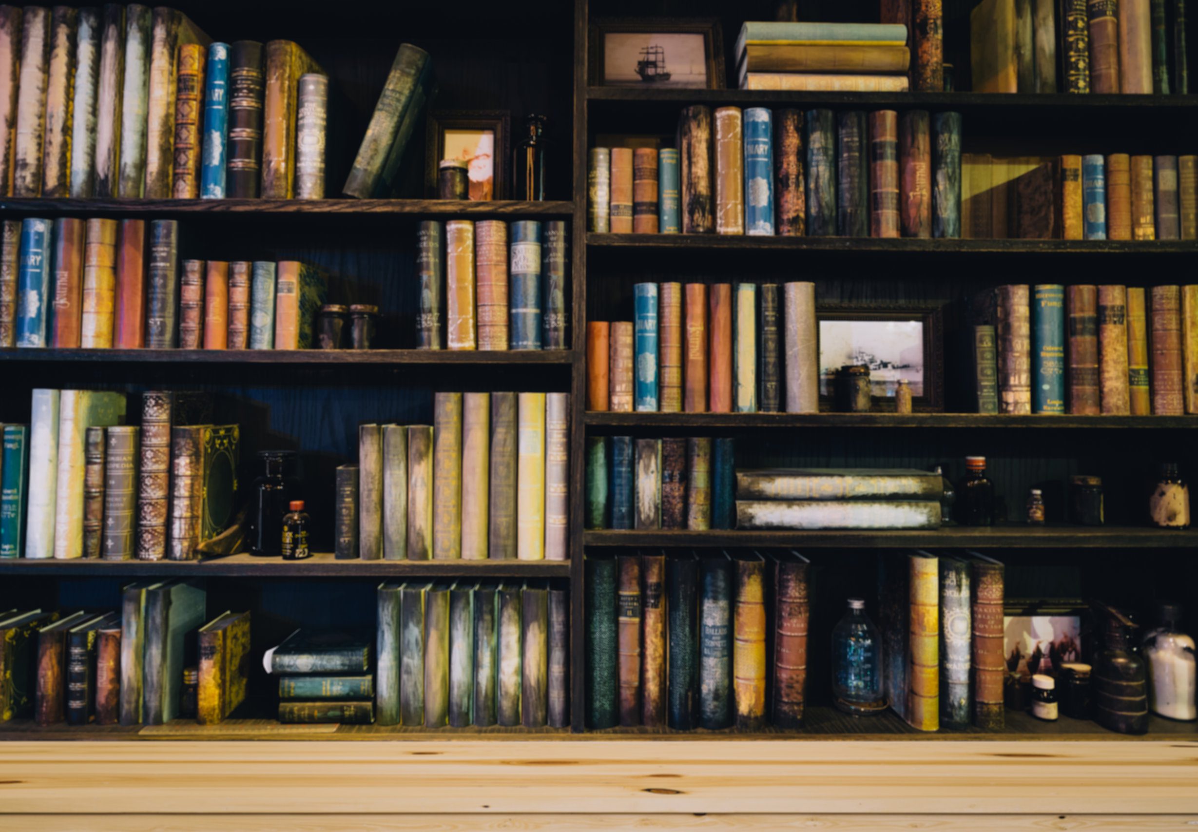 blurred Image many old books on bookshelf in library Midsection Of Lawyer With Arms Crossed